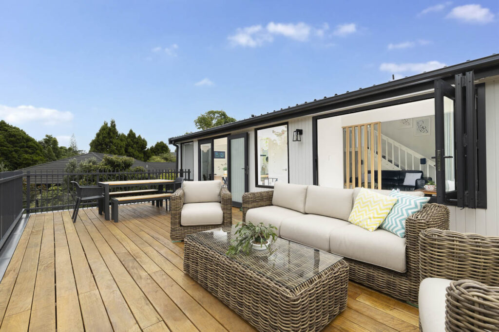 After photo of a newly renovated outdoor deck, perfect for relaxing and enjoying the beautiful backyard.