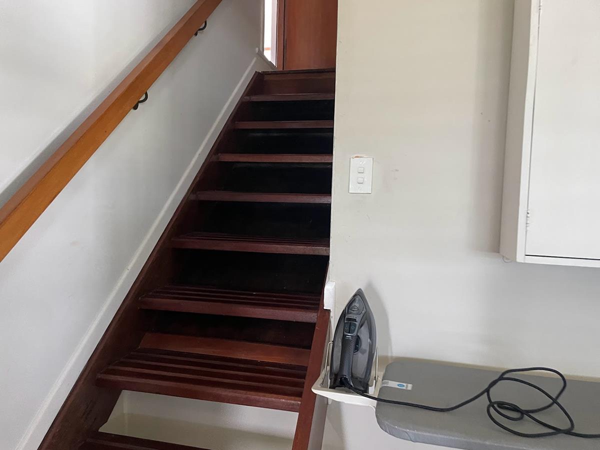 Original-staircase-prior-to-renovation-–-dated-timber-handrail-and-enclosed-walls