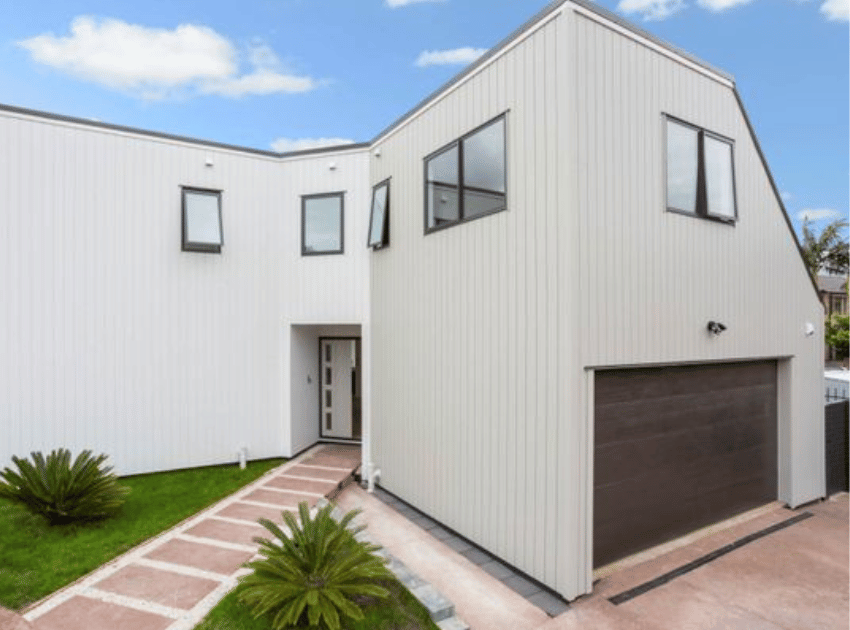 Completed recladding with new second-storey extension in vertical weatherboard — Epsom plaster home reclad by Add Value Renovations