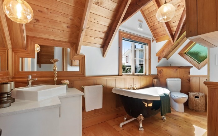 Renovated Lockwood bathroom with clawfoot tub and tongue-and-groove timber lining