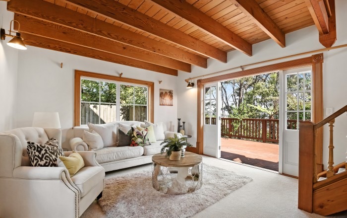 Lockwood lounge with exposed timber beam ceiling and French doors to deck