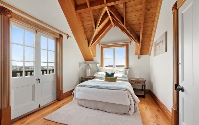 Lockwood master bedroom with vaulted pine ceiling and French doors