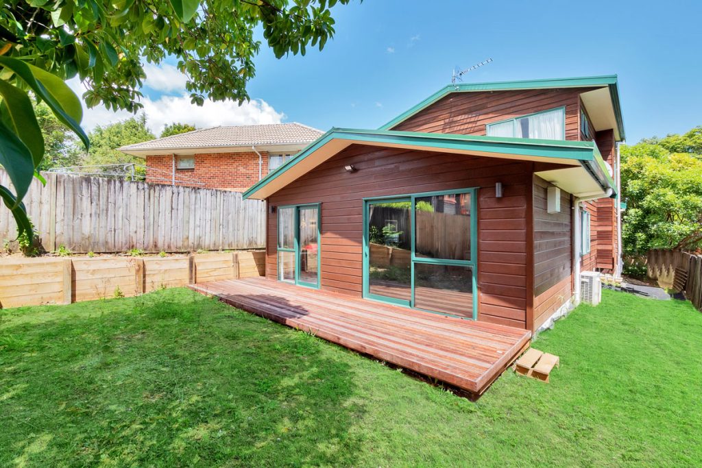 Single-storey home extension with timber deck and large glass sliding doors — Queenstown Road extension by Add Value Renovations