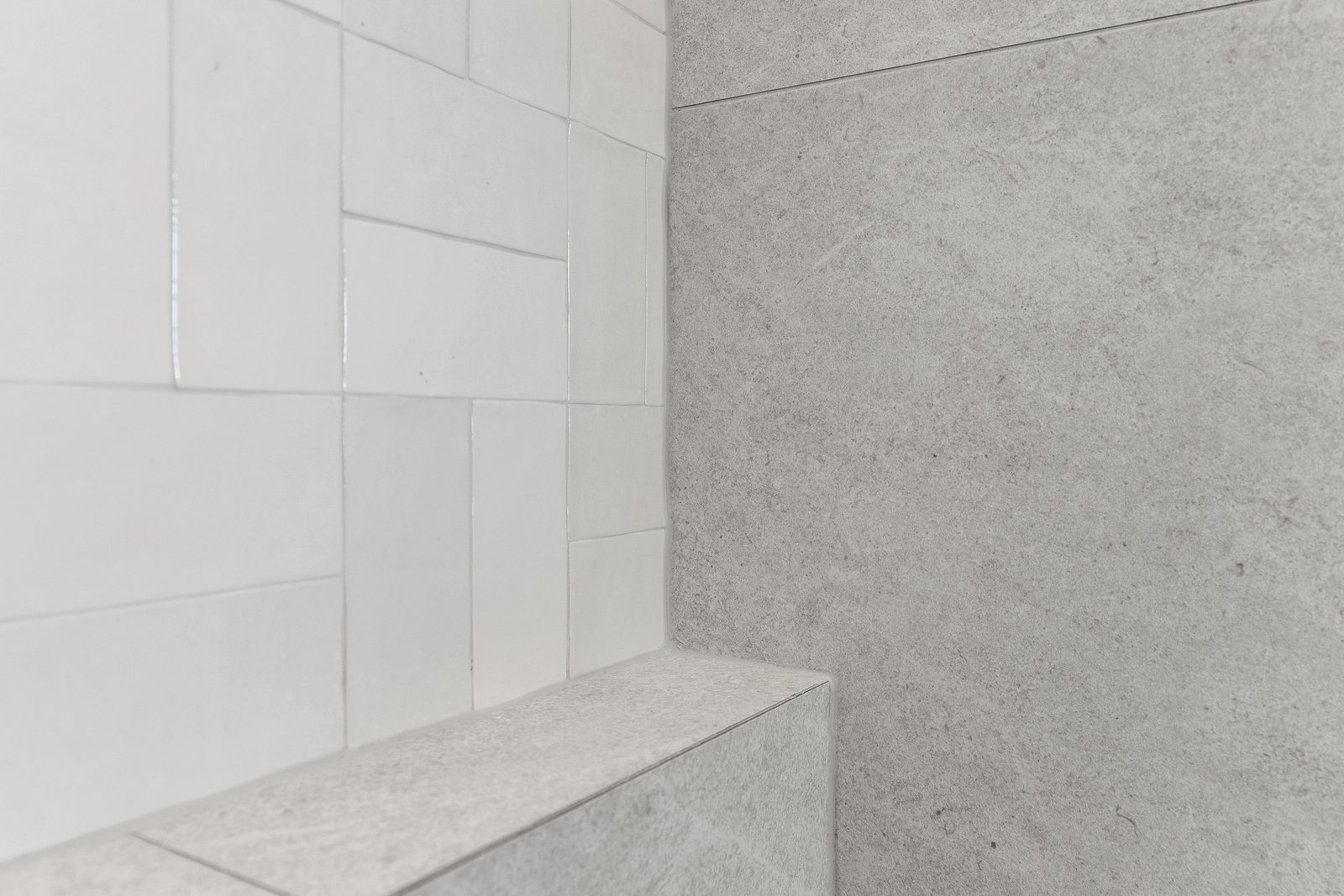 Fez White gloss feature tile meeting Caesar Bianco stone-look tile — Remuera ensuite detail