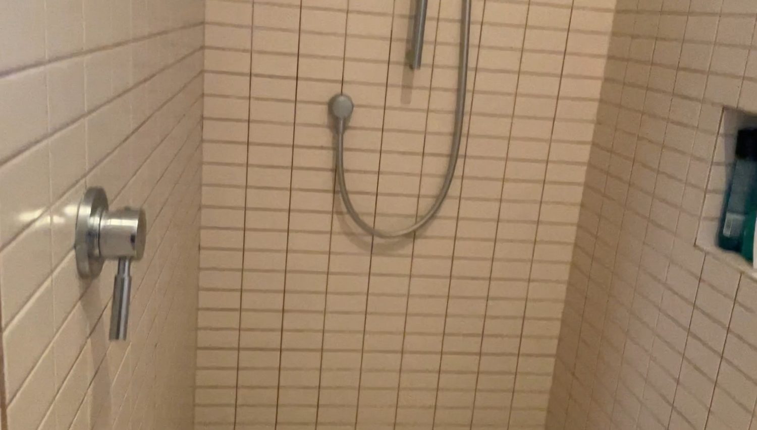 Remuera ensuite before renovation — tired wall tiling and ageing grout in the old shower