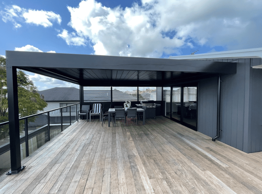 Furnished rooftop deck with Louvretec opening roof and black louvre screens — Mt Roskill second storey extension by Add Value Renovations